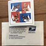 dog stamps on top of postal envelope