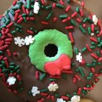 chocolate donut with red and green sprinkles plus sugar wreath and snowflakes