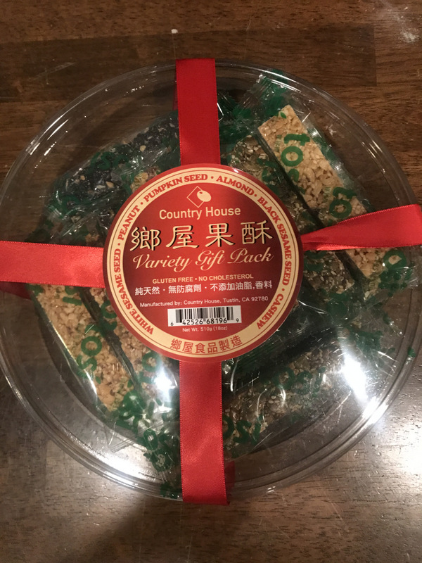 Round container of nuts-and-sesame sticks for lunar new year