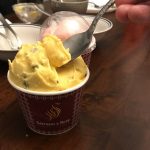 Two cups of stretchy ice cream from Saffron & Rose: a yellow version with saffron and pistachio, and a pink version with rosewater and California cactus pear
