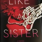 Red book cover of Like A Sister with faux pearl necklace laid on top of it